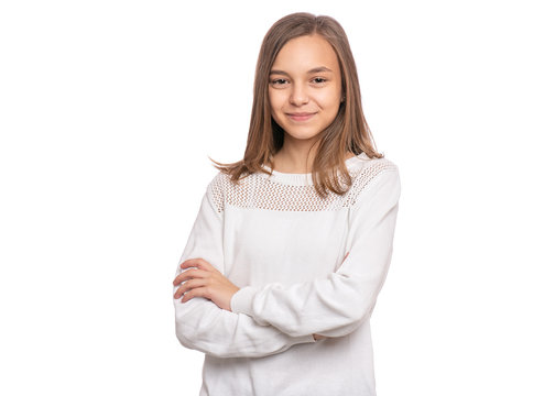 Beautiful Teen Girl Student with confident expression, keeps arms folded. Portrait of Smiling Teenager isolated on white background. Happy child looking at camera.