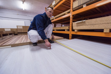 carpenter measuring wooden board