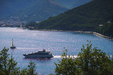 Obraz premium Mediterranean seascape: cozy town with old stone houses red roofs and mountains background.