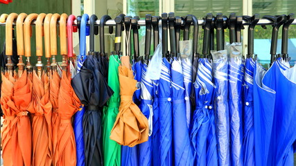 Close up group of Many umbrellas hung on hangers 