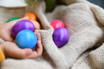 Fototapeta na wymiar Easter eggs in the hands of children