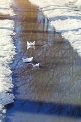 early spring landscape. paper boat, symbol of childhood, spring meeting. spring season, paper boat in stream. 