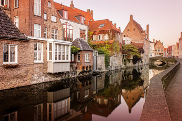 Fototapeta na wymiar Reflections on the canal water, in Bruges