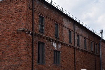 Fototapeta na wymiar low brick buildings across a narrow street, interesting old architecture