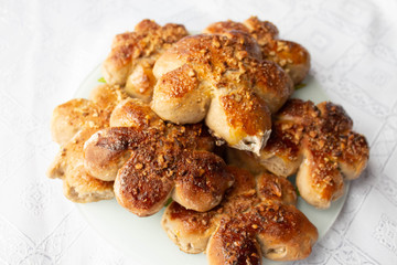 Freshly baked homemade buns with nut topping. Cocoa dough. Tasty, appetizing homemade cakes on a white background