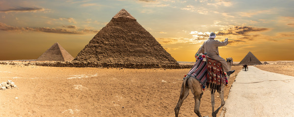 The Great Pyramids of Giza and a bedouin, desert panorama
