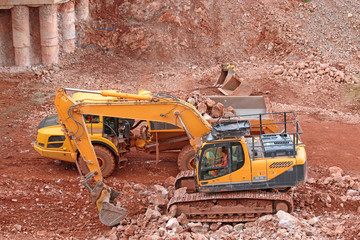 digger loading a dump truck on a road construction site