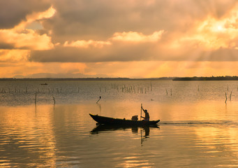 fishing boat at sunset on the lake in Sri Lanka