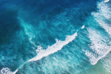 Fototapeta premium Waves as a background from top view. Turquoise water background from top view. Summer seascape from air. Gili Meno island, Indonesia. Travel - image