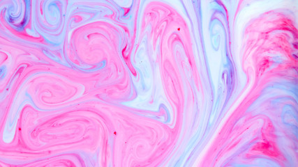 Abstract multicolored background. Screen saver. Fluid art with pink blue color. Blue pink texture. Colored paint stains in liquid