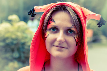 Woman in orange squirrel suit. Fairy tale character from fantasy. Girl in the hoodie with the ears...