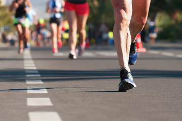 Marathon running race, people feet on city road