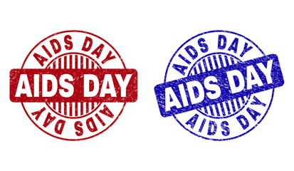 Grunge AIDS DAY round stamp seals isolated on a white background. Round seals with grunge texture in red and blue colors. Vector rubber imitation of AIDS DAY text inside circle form with stripes.