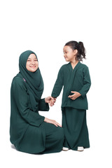 Malay mother and daughter in traditional dress posing