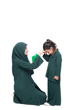 Daughter asking for forgiveness from mother during Raya, a muslims festive celebration