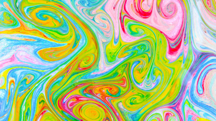 Fluid art with different colors. Screen saver. Multicolored background from paints on liquid. Bright pattern on liquid. Colored paint stains in pop art style