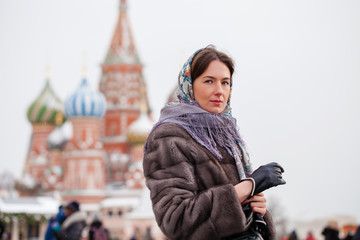 Young woman in fur mink coat on a red square in the center of Moscow