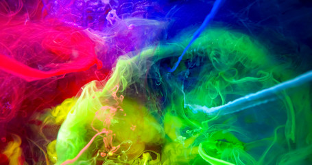 Fototapeta na wymiar Colorful Rainbow Paint Threads and Drops Mixing in Water. Ink swirling. Underwater 4K Macro Shot.