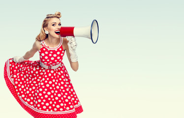 happy woman holding megaphone, dressed in pin-up style red dress