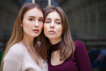 Two brunette young women, indoor