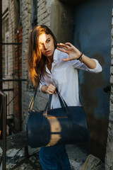 Obraz na płótnie Canvas Girl in the city with a bag