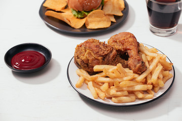 Fast food hamburger with set fried crispy chicken and french fries, ice cola on the side