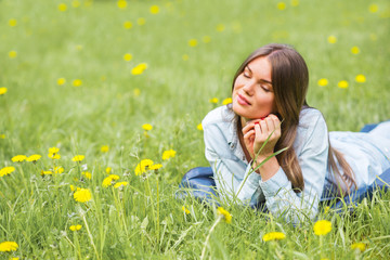 Fototapeta premium Woman laying on grass in park