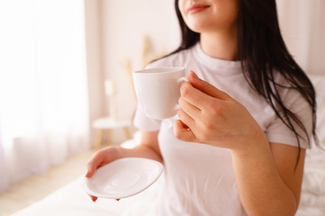 good morning. young woman enjoying a cup of coffee in early morning. daily routine, starting new day, good mood and harmony