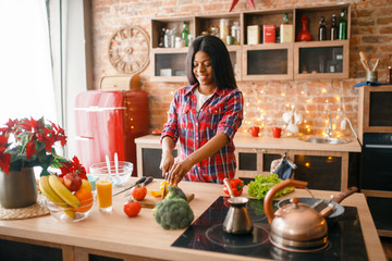 Black woman cooking healthy breakfast on kitchen