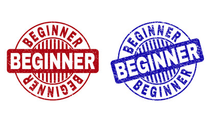 Grunge BEGINNER round stamp seals isolated on a white background. Round seals with grunge texture in red and blue colors. Vector rubber overlay of BEGINNER tag inside circle form with stripes.
