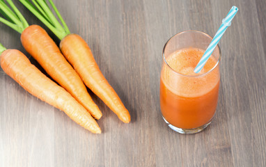 Fresh Healthy Carrot Juice on wooden background
