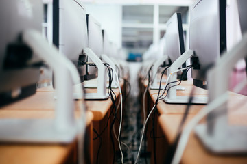 Group of desktop computers on the table in computer lab room - Close-up shot