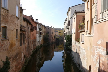 Fototapeta na wymiar Views walking on the bridges along Rio river in Mantova