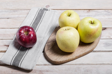 Raw delicious apples golden on wood background