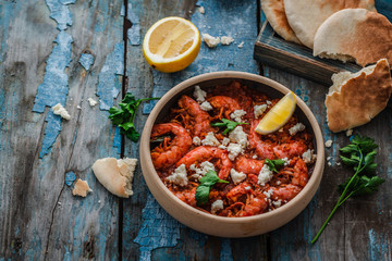 Big shrimps in tomato sauce with feta cheese or saganaki, copy space