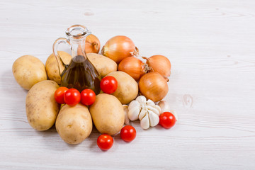 Fresh vegetables ingredients on white wood background