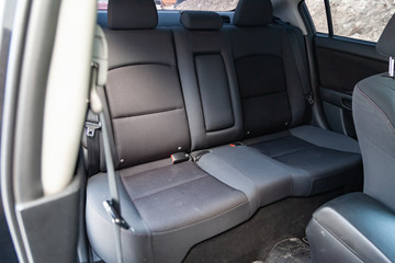 The interior of the car with a view of the s rear seats with light gray trim