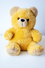 brown toy soft bear on white background childhood concept
