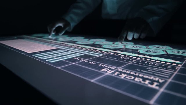 Man indicators on sensor touch screen sensory interactive table in the dark. 