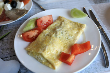 Omelet with vegetables on plate
