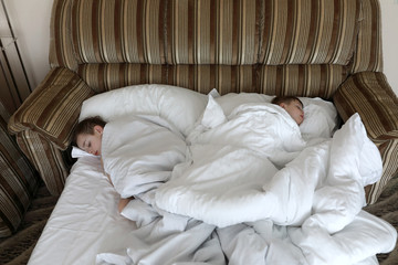 Fototapeta na wymiar Two brothers sleeping in bed