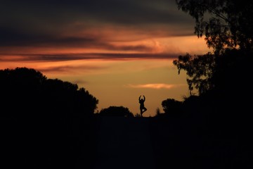 Happy yoga woman on sunset