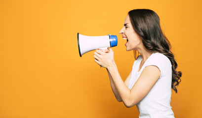 Hullabaloo. Fierce girl with long curly hair is piping someone up through the megaphone near the...