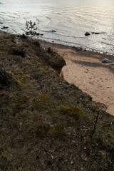 Moss sand and moody cloudy sky on the Baltic Sea close to sunset - Veczemju Klintis, Latvia - April 13, 2019