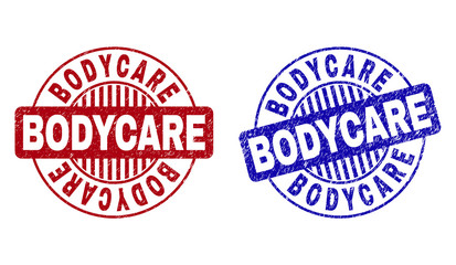 Grunge BODYCARE round stamp seals isolated on a white background. Round seals with grunge texture in red and blue colors. Vector rubber overlay of BODYCARE text inside circle form with stripes.