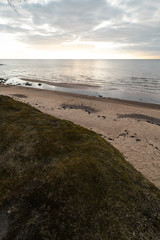 Moss sand and cloudy sky on the beach on the Baltic Sea - Veczemju Klintis, Latvia - April 13, 2019