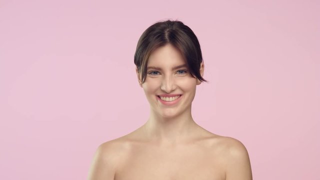 Young brunette woman throws out women shave razor and smiles.