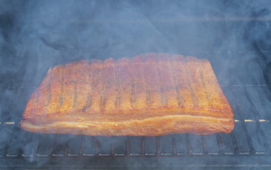 Grilled barbecue bacon the grill with smoke in the hot smoked