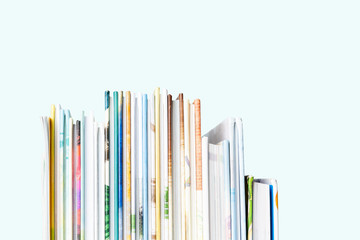 Close view of Stack of children's books on a pastel blue background.