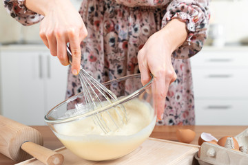 Young beautiful girl making dough